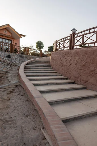 Tiered engineered retaining wall with custom block masonry