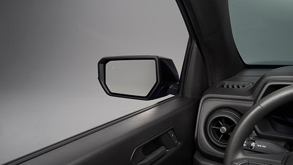 Outside heated power-adjustable mirrors